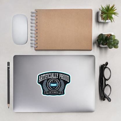 Artificially Proud sticker on a laptop, desk flat lay