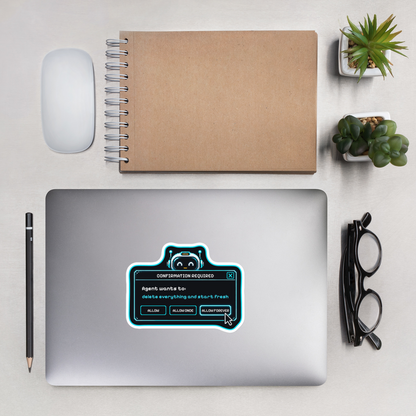 Confirmation Required sticker on a laptop, desk flat lay